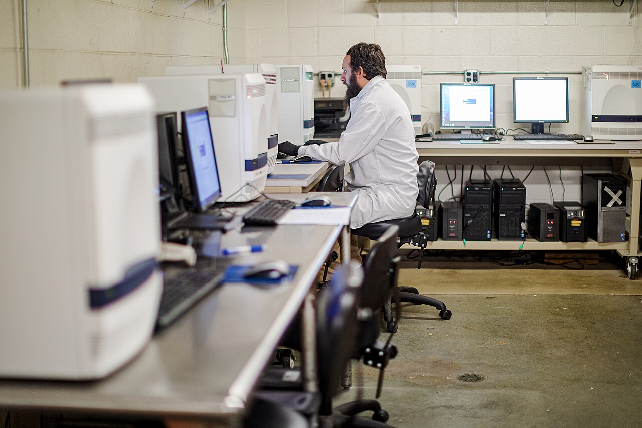 Laboratory technician in protective equipment conducting mpox diagnostic testing