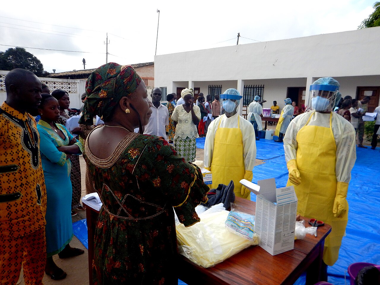 Healthcare worker in protective equipment supporting a patient in an Ebola treatment unit